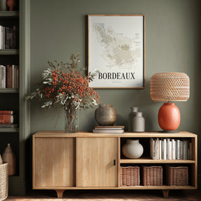 Bordeaux Wine Map poster by Corkframes in a wooden frame above an oak sideboard with books and dried flowers