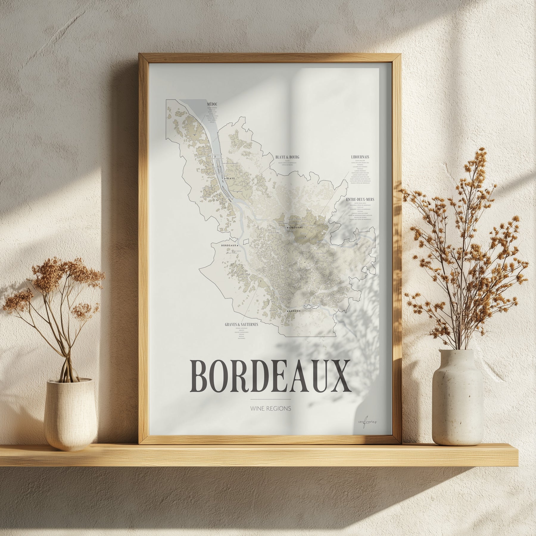 Bordeaux Wine Map poster by Corkframes in an oak frame resting on a wooden shelf with dried flowers