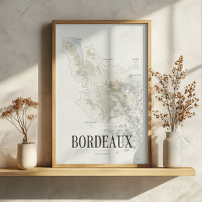 Bordeaux Wine Map poster by Corkframes in an oak frame resting on a wooden shelf with dried flowers