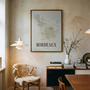 Bordeaux Wine Map poster by Corkframes framed above a desk, with a sheepskin chair and a pendant lamp