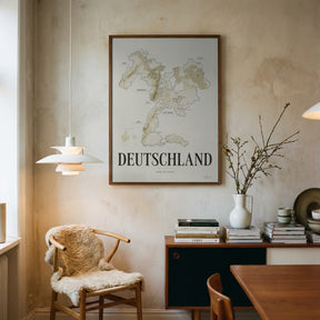 Deutschland Wine Map poster by Corkframes framed on a plaster wall above a desk, with a sheepskin chair and a pendant lamp