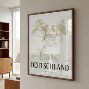 Deutschland Wine Map poster by Corkframes in a walnut frame on a plaster wall beside a bookcase and a sunlit window