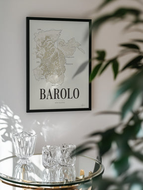 Barolo Wine Map poster by Corkframes framed on a wall behind a glass drinks trolley and a plant