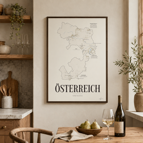 Österreich Wine Map poster by Corkframes framed in a kitchen above a dining table with pears, a wine bottle and a glass of white wine