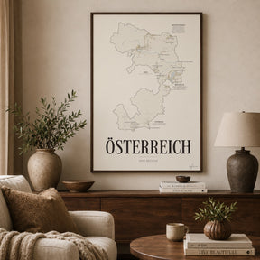 Österreich Wine Map poster by Corkframes framed above a sideboard in a living room, with an olive branch in a stone vase and a ceramic lamp